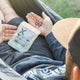 a person holding 200mg hard candy edibles by xite in their hand