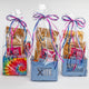 3 wrapped giftbags containing various xite edible products