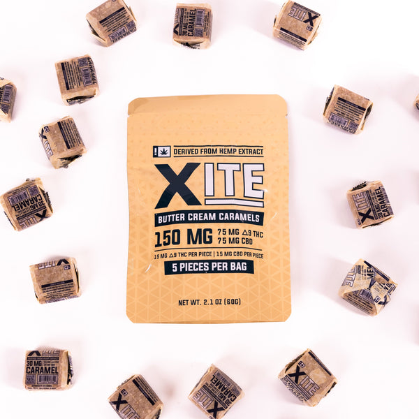 bag of 150mg butter cream caramels by xite with individual caramels surrounding it