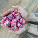hands holding 30mg strawberry chews by xite